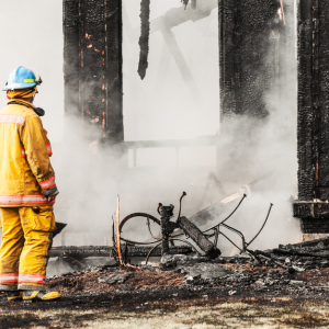 Man looking at burnt building